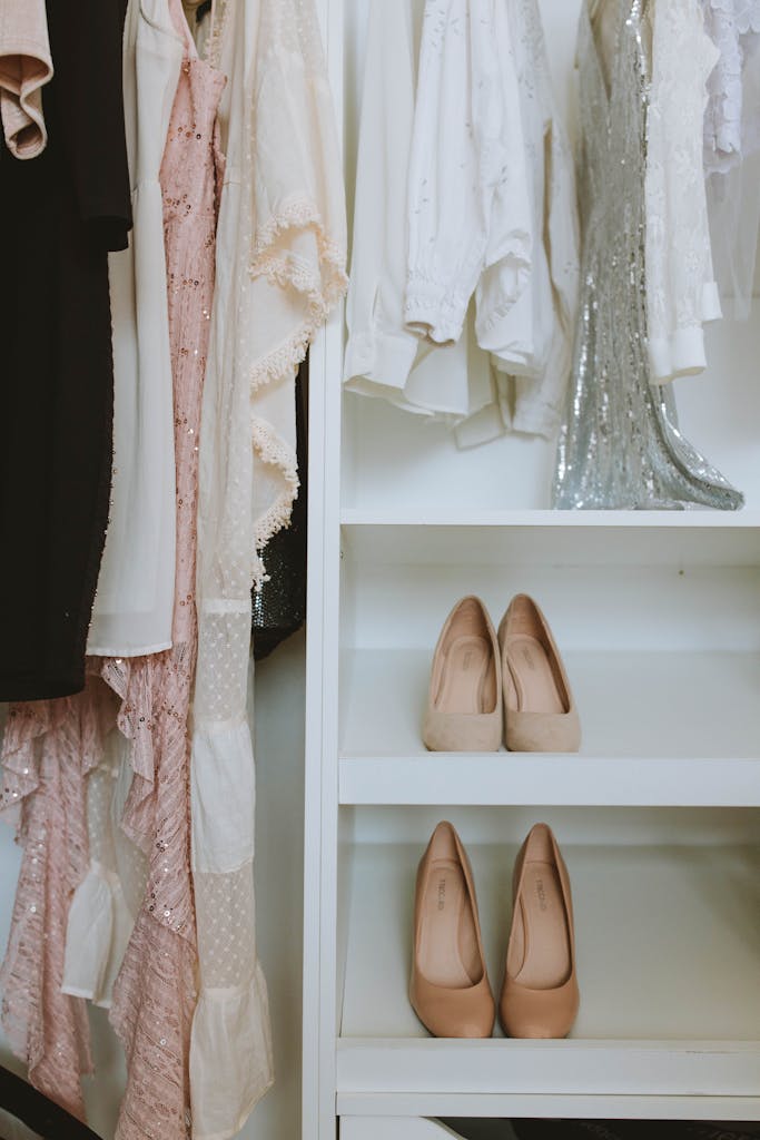 Elegant wardrobe showcasing luxury fashion with beige shoes and delicate clothing.